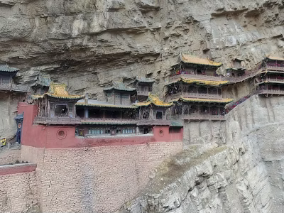 Ancient Cliffside Architecture With Multi Story Structure Yellow Roofs And Red Walls 3d model