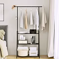Stylish Multi Tiered Clothing Rack With Hanging Clothes Black Handbag Books And Photo Frame