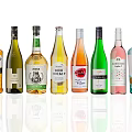 Various Wine Bottles with Colorful Labels Arranged in Row on White Background with Reflection