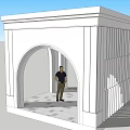 White Architectural Structure With Arched Doorway And Standing Person