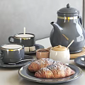 Gray Ceramic Teapot And Gold Rimmed Coffee Cups With Plates Croissants And Pastries