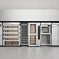 Stainless Steel Commercial Kitchen Appliances Setup With Ovens Refrigerators And Storage Units