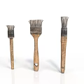 Three Old Brushes Of Various Sizes With Wooden Handles And Worn Bristles On White Background