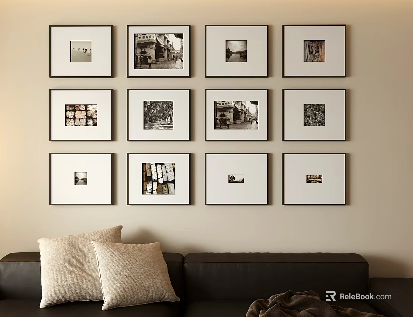 Neatly Arranged Photo Wall with Multiple Framed Photos and Black Sofa with Pillows 3d model 