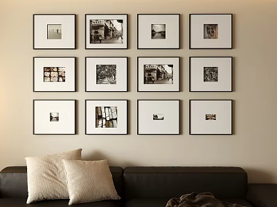 Neatly Arranged Photo Wall with Multiple Framed Photos and Black Sofa with Pillows 3d model