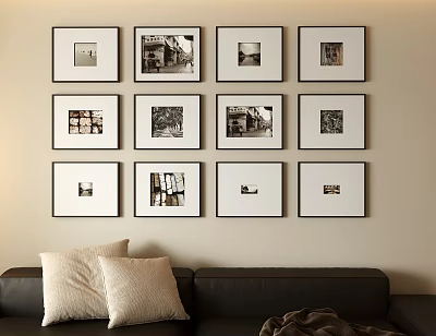 Neatly Arranged Photo Wall with Multiple Framed Photos and Black Sofa with Pillows 3d model