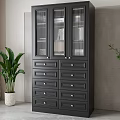 Modern Black Bookcase With Glass Doors Drawers And Gold Handles Near Green Plant