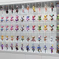 Collection of Various Colored and Styled Dolls Arranged Neatly on White Shelves