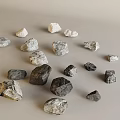 Various Sizes And Colors Of Stones And Wood Scattered On Light Background