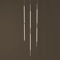 Three Vertically Hanging Long Pendant Lights With White Body Metal Accents Dark Brown Background