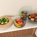 Green Apples Bananas Peaches in Wire Baskets Wooden Tray and Grey Bowl on Kitchen Countertop