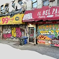 Urban Commercial Street With 99 Cent Store Sign Graffiti Roller Shutters And Weathered Buildings