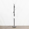 Modern Floor Lamp With Black Metal Stand And Multiple White Globe Shades For Home Interior
