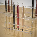 Different Colored Pens Placed in Metal Pen Holders on Wooden Table