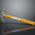 Claw Hammer With Metal Head And Yellow Wooden Handle On Gray Background