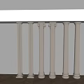 White Decorative Columns In Various Styles Against Light Wall And Wooden Floor