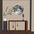 Brown Console Table with Green Branch and Blue Deer Statue Against Wall with Moon Decor