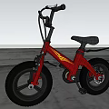 Red Balance Bike With Large Wheels Black Seat And Yellow Accents In Outdoor Field