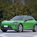 Green Modern Electric Car Sleek Exterior Design With Tree Background And Outdoor Road