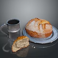 Fresh Crusty Bread On Silver Plate With Sliced Piece And Silver Mug And Crumbs