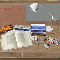 Wooden Desk With Gray Chair Open Book Stationery Lamp Shelf Books Flower In Vase Plant