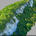 Scenic Cliff Terrain Adorned With Lush Green Vegetation And Natural Rock Formations