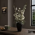 White Flowers In Black Vase On Wooden Table With Coffee Cup And Sunglasses Near Window