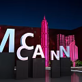Modern Floral Installation with Pink Lighting Green Plants and Architectural Silhouettes in Night Venue