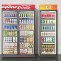 Upright Display Freezers With Coca Cola And Fanta Stocked With Various Beverages