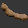 Fresh Ripe Tamarind Fruit with Natural Brown Texture on Dark Surface