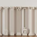 Various Styles of White Classical Columns Displayed Against Light Wall And Wooden Floor