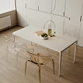Modern White Dining Table Set With Transparent Chairs Golden Legs And Green Fruit Bowl