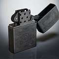 Black Metal Engraved Lighter With Open Lid And Intricate Patterns