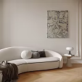 White Curved Multi Seater Sofa With Decorative Pillows Side Table Lamp And Abstract Wall Art