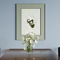 Framed Abstract Painting On Light Blue Wall With White Flower Vase And Green Elements
