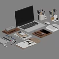 Laptop With Office Supplies Notebook Mouse Pens And Papers On Workspace