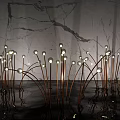 Illuminated Outdoor Lights With Grass like Copper Stems Round Bulbs And Marble Wall Reflections