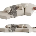 Beige Sectional Sofa with Pillows Blanket and Side Table in Modern Living Room