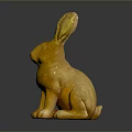 Golden Rabbit Statue In Sitting Position With Shiny Metallic Finish Against Dark Background