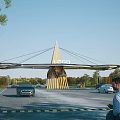 Modern Design Entrance Gate with Golden Umbrella Like Top Logo and Cars in Parking Area