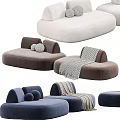 Curved Modular Sectional Sofa with Neutral Blue Upholstery Decorative Pillows and Throw Blanket