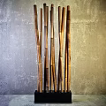 Natural Bamboo Stems with Brown and Yellow Tones Arranged on Black Base Against White Background
