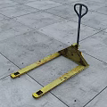 Yellow Forklift Pallet With Metal Handle On Gray Concrete Floor Surface