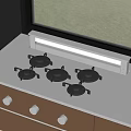 Modern Five Burner Gas Stove On Stainless Steel Countertop By Window With Green Grass