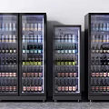 Three Commercial Glass Door Display Refrigerators Stocked With Various Bottled Beverages
