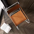 Modern Leisure Chair with Brown Seat Metal Frame near Stack of Books and Pink Table