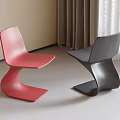 Modern Red And Black Dining Chairs With Curved Design In Interior Space