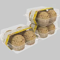 Transparent Plastic Packaged Cupcakes With Yellow Labels And Patterned Tops Stacked Together