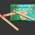 Colorful Wooden Matches With Orange Tips And Green Patterned Matchbox