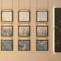 Nine Gold Framed Landscape Paintings On Beige Wall With Green Plant And Dark Decorative Panel
